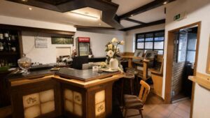 Verdo Hotel boutique bar and lounge area with wooden counter, warm lighting, and cozy seating atmosphere.