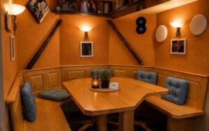 Private wooden booth seating area inside Verdo Hotel bar with warm lighting and cozy boutique atmosphere.