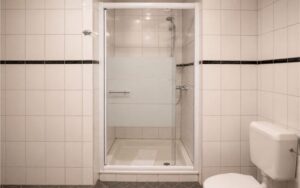 Minimal Verdo Hotel double room bathroom with glass shower cabin, white tiled walls, and clean modern boutique hotel design.