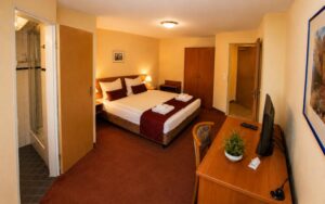 Spacious Verdo Hotel double room with comfortable double bed, workspace desk, warm lighting, and modern boutique hotel interior.