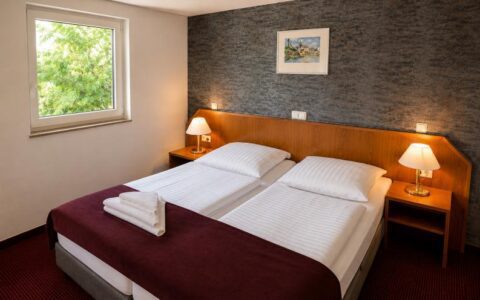 Verdo Hotel double room with comfortable double bed, warm bedside lighting, and modern boutique hotel bedroom interior.