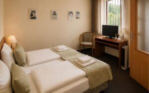 Verdo Hotel double room with comfortable double bed, workspace desk, warm lighting, and clean boutique hotel interior.