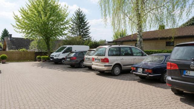 Free outdoor parking area at Verdo Hotel with guest parking spaces surrounded by greenery.