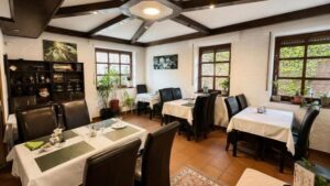 Bright dining area inside Verdo Hotel restaurant with elegant table settings, wooden beams, and natural daylight.