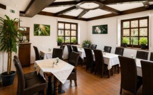 Elegant Verdo Hotel restaurant interior with stylish dining tables, natural daylight, wooden ceiling beams, and warm boutique atmosphere.