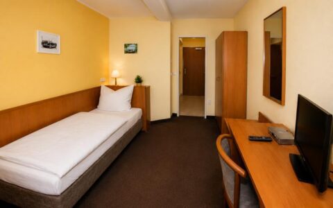 Verdo Hotel single room with comfortable single bed, workspace desk, TV, and clean modern boutique hotel interior.