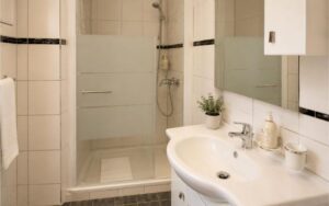 Verdo Hotel single room bathroom with modern sink vanity, walk-in shower, and clean bright boutique hotel interior.